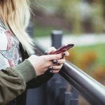 woman holding red phone