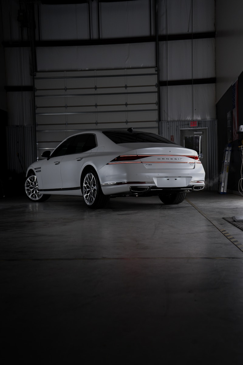 A white car is parked in a garage