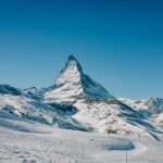 A man riding skis down a snow covered slope