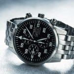 Close-up shot of a sleek stainless steel chronograph watch with black dial.