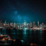 A mesmerizing view of New York City's illuminated skyline under a starry night sky.