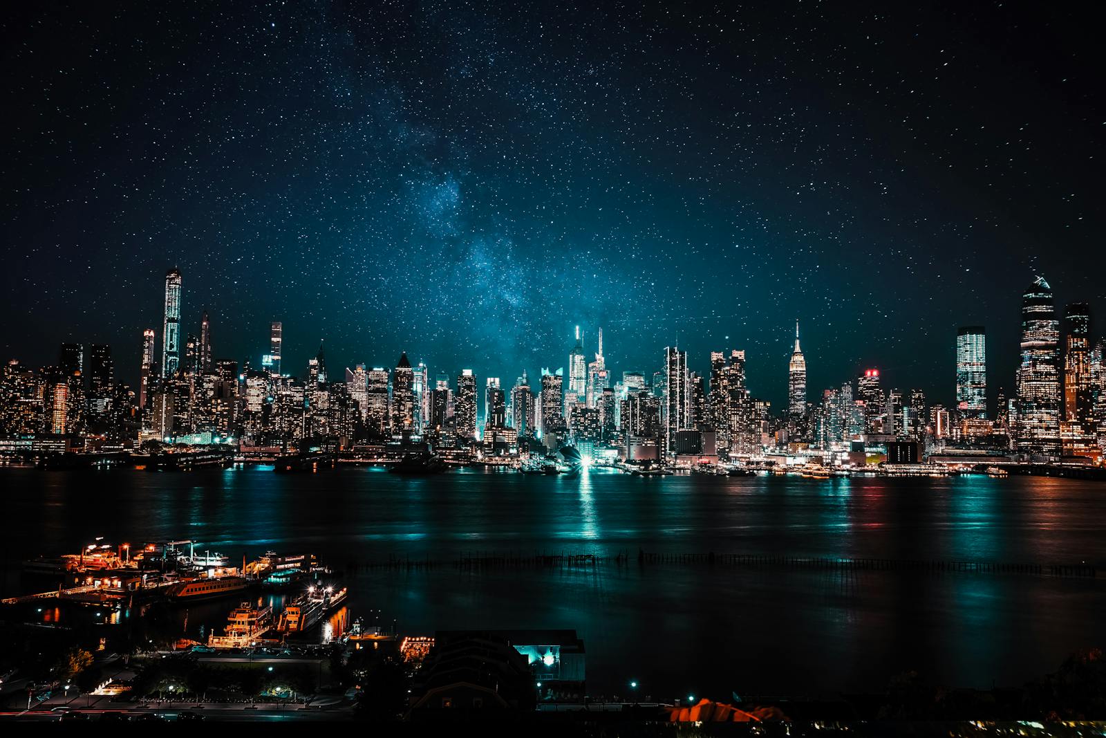 A mesmerizing view of New York City's illuminated skyline under a starry night sky.
