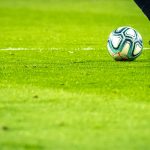 man playing soccer game on field