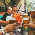 people holding drinks during day