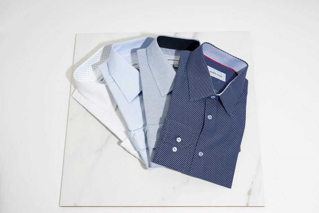 blue button up shirt on white table