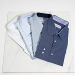 blue button up shirt on white table