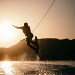 person wake boarding on body of water